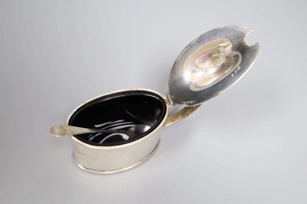 An Edwardian oval silver lidded mustard pot and matching spoon, Stokes & Ireland, Chester, 1905,